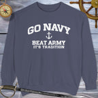 Navy blue sweatshirt with 'Go Navy, Beat Army, It's Tradition' text on a wooden background.