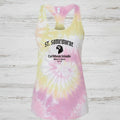 A women's racerback tank top with a pink, yellow, and white spiral tie-dye pattern. The front features a graphic print with the text 'ST. Somewhere, Caribbean Islands, Where it's warm. Since 1946