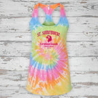 A racerback tank top with a vibrant rainbow tie-dye spiral pattern, featuring a graphic print on the front that reads 'ST. SOMEWHERE' and 'Caribbean Islands' in pink text with a parrot illustration.
