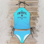 Blue bikini set with 'Fintastic Athletics' text on a wooden surface