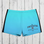 Blue athletic shorts with 'Fintastic Athletics' branding on rustic nautical background