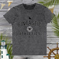 Gray t-shirt with 'Fintastic Athletics' text on a wooden background with decorative elements.