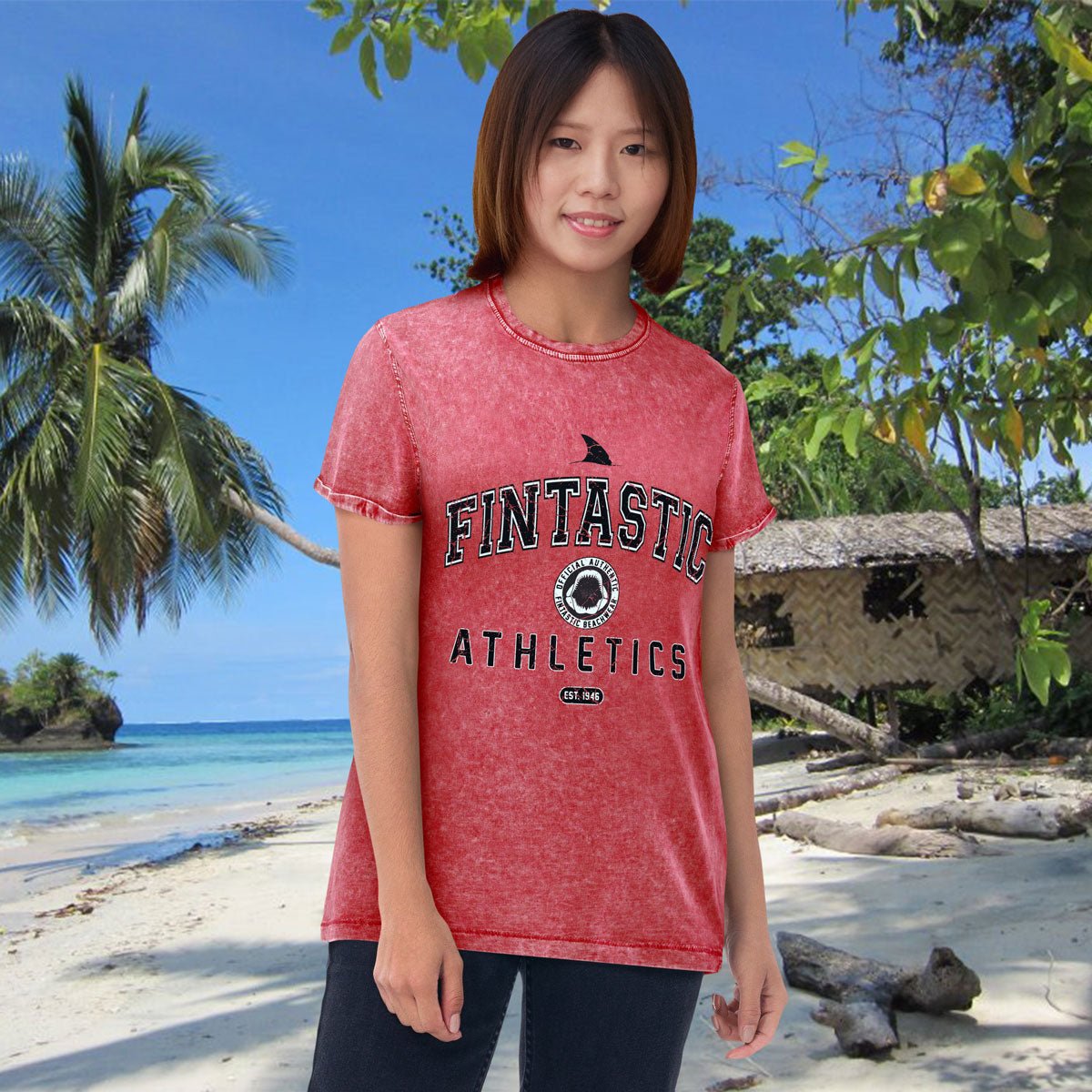 Person wearing a red 'FINTASTIC ATHLETICS' shirt on a tropical beach