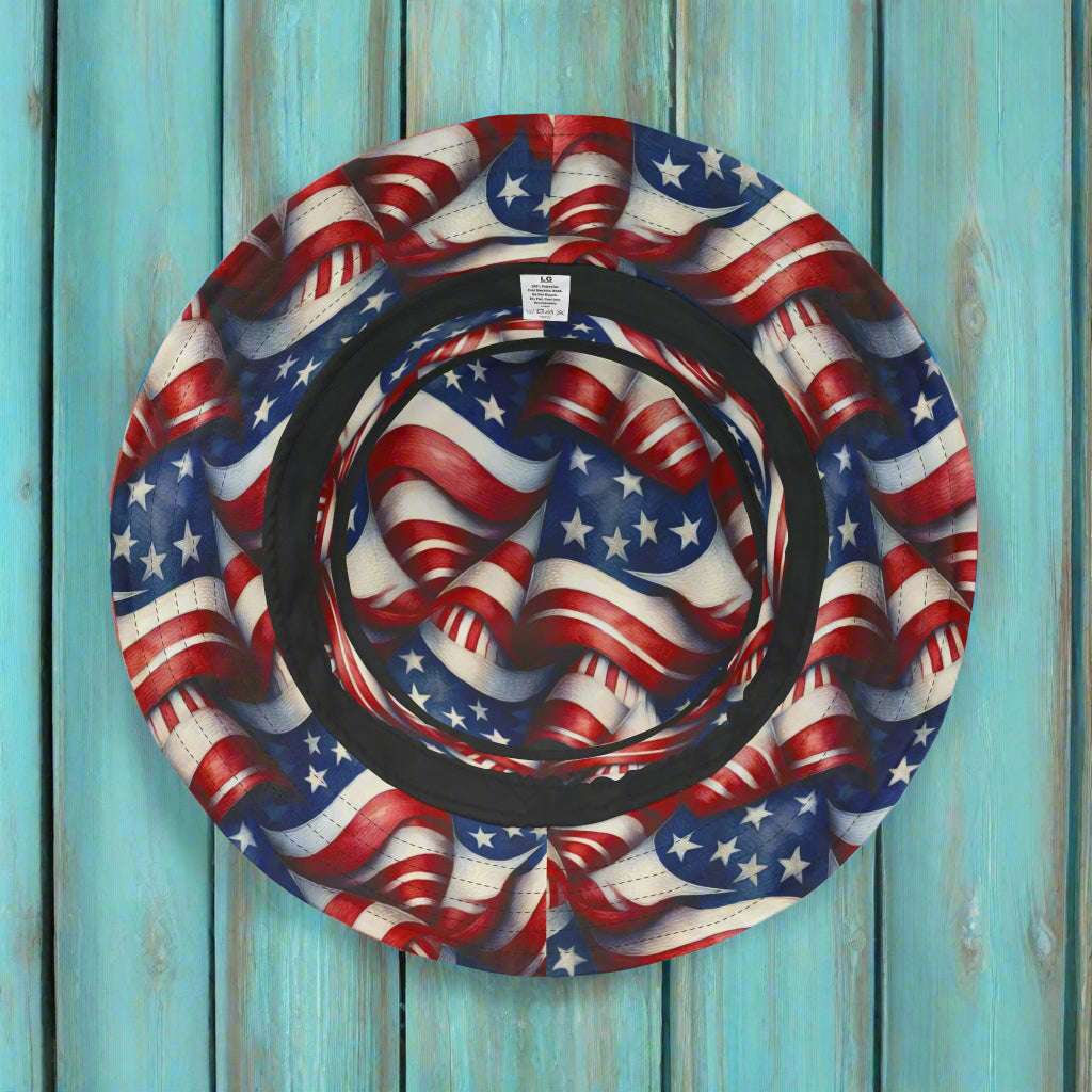 USA Flag Pattern Bucket Hat laying on a turquoise rustic wood deck 