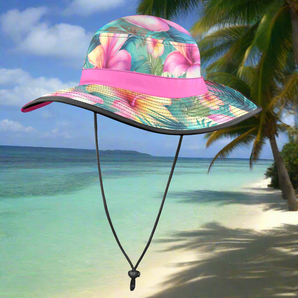 Colorful floral bucket hat with a pink band on a beachy background