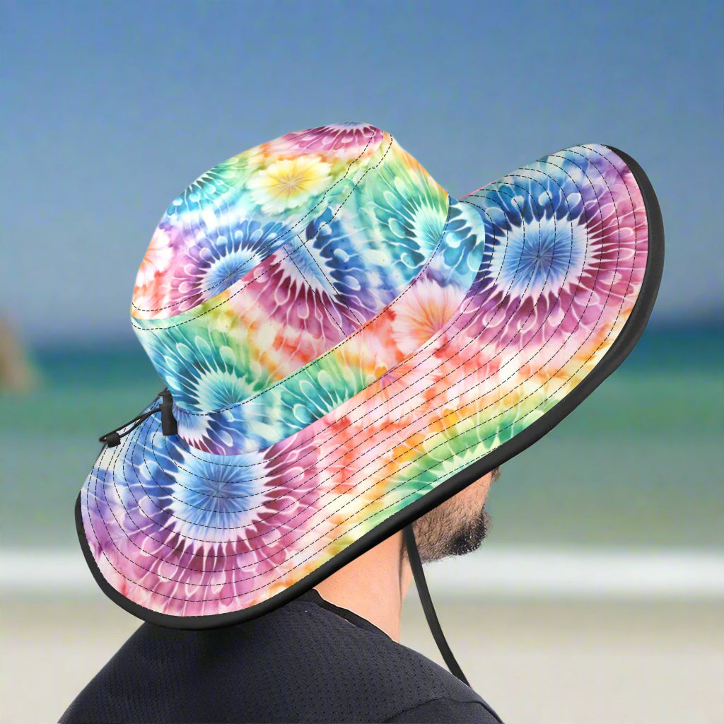 Colorful tie-dye bucket hat with a black rim on a guy surf fishing in Pensacola 