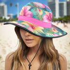 Colorful Hawaiian floral sun hat with pink band worn by a swimsuit model on Waikiki Beach