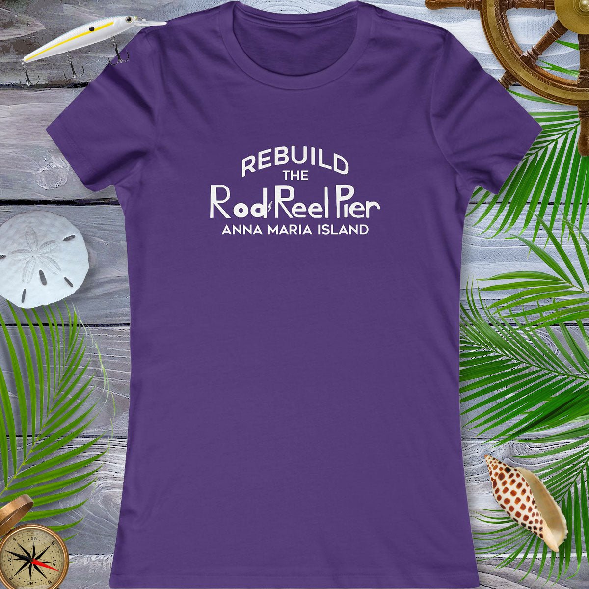 Purple t-shirt with text on a wooden surface with beach elements