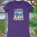 Purple t-shirt with 'AMI Strong' graphic on a wooden surface with decorative elements.