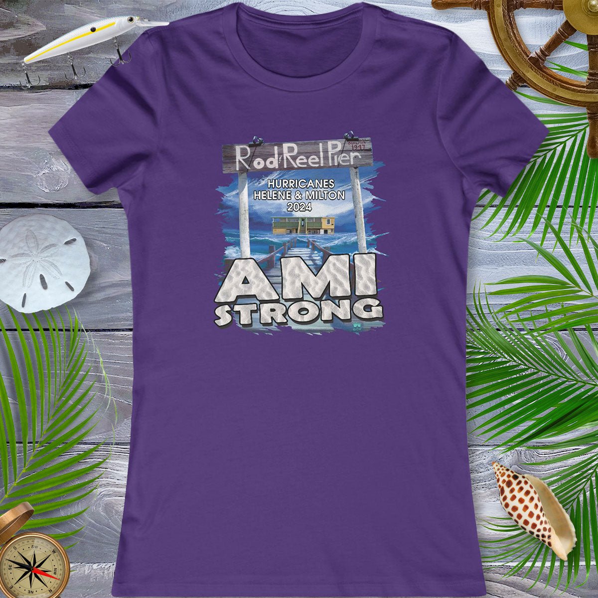 Purple t-shirt with 'AMI Strong' graphic on a wooden surface with decorative elements.