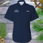 Women's Navy blue Fishing shirt with Fundraiser logo on a wooden surface with decorative elements
