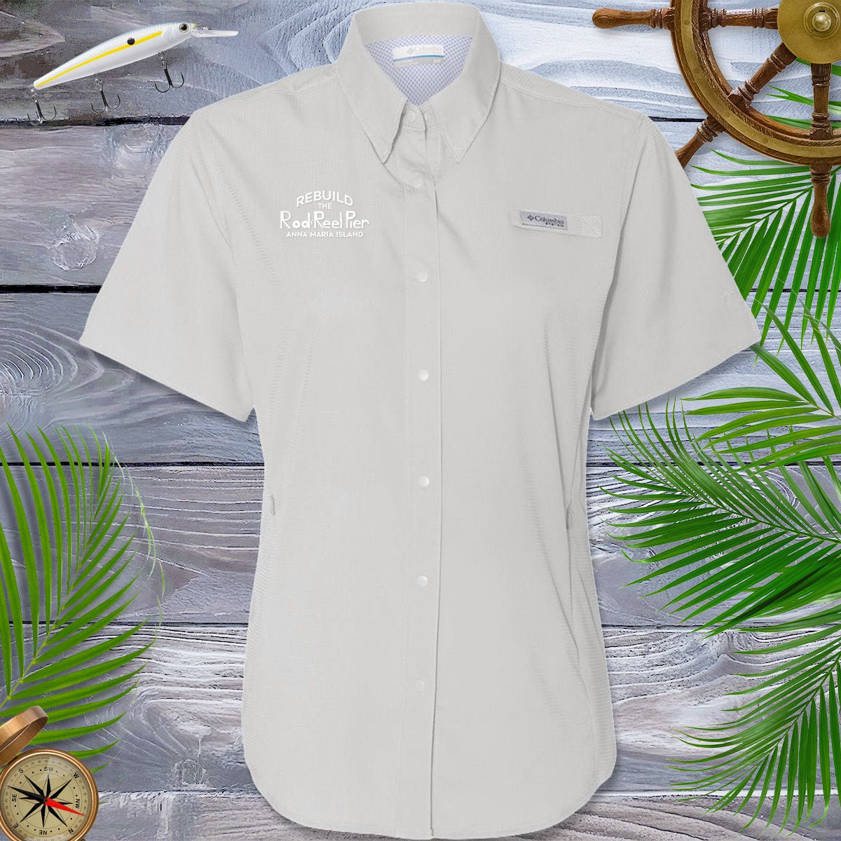 Beige short-sleeve shirt with brand logos on a wooden background with decorative elements.
