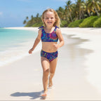 Little girl wearing Colorful Kids Tribal Two Piece Swimsuit set on a tropical island beach