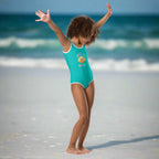 Girl in Turquoise One Piece Swimsuit saying SHello Gwama design dancing on Pensacola Beach