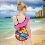 Girl showing backside of Colorful swimsuit with floral design and pink ruffled top on Waikiki Beach