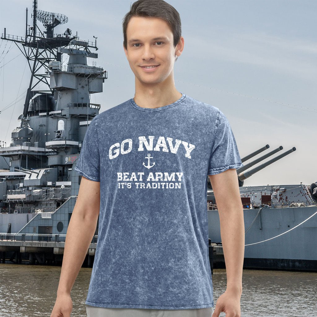 Person wearing a 'Go Navy Beat Army It's Tradition' t-shirt with a navy ship in the background