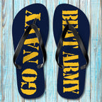 Pair of navy blue flip-flops with yellow text on a wooden surface