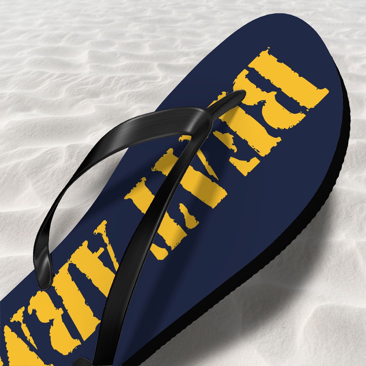 Flip-flop with yellow text on a textured white surface