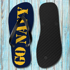 Flip-flop sandal with 'GO NAVY' text on a wooden surface