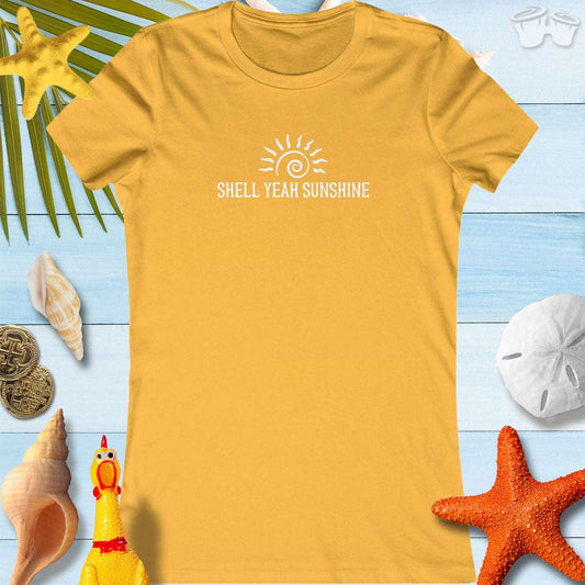 SHELL YEAH SUNSHINE Women's vibrant summer t-shirt on a beach-themed background with shells and starfish.