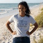 Woman wearing a t-shirt with a beach-themed quote on a sandy beach.
