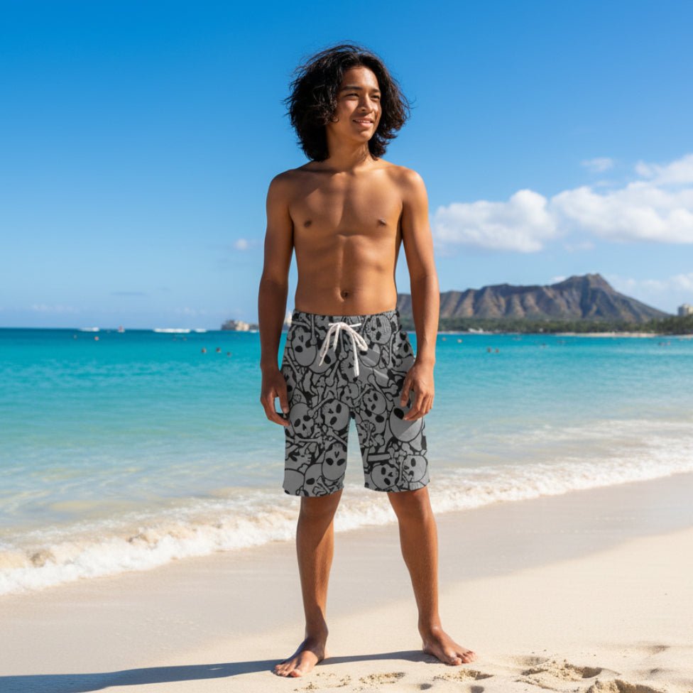 Young pacific islander dude wearing gray shorts with black skull pattern on Waikiki Beach