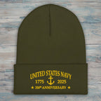 An olive green knit cuffed beanie with yellow embroidered text reading 'UNITED STATES NAVY 1775 2025 250th ANNIVERSARY' and an anchor motif on the front cuff.