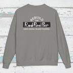 Gray sweatshirt with text on the back on a wooden surface