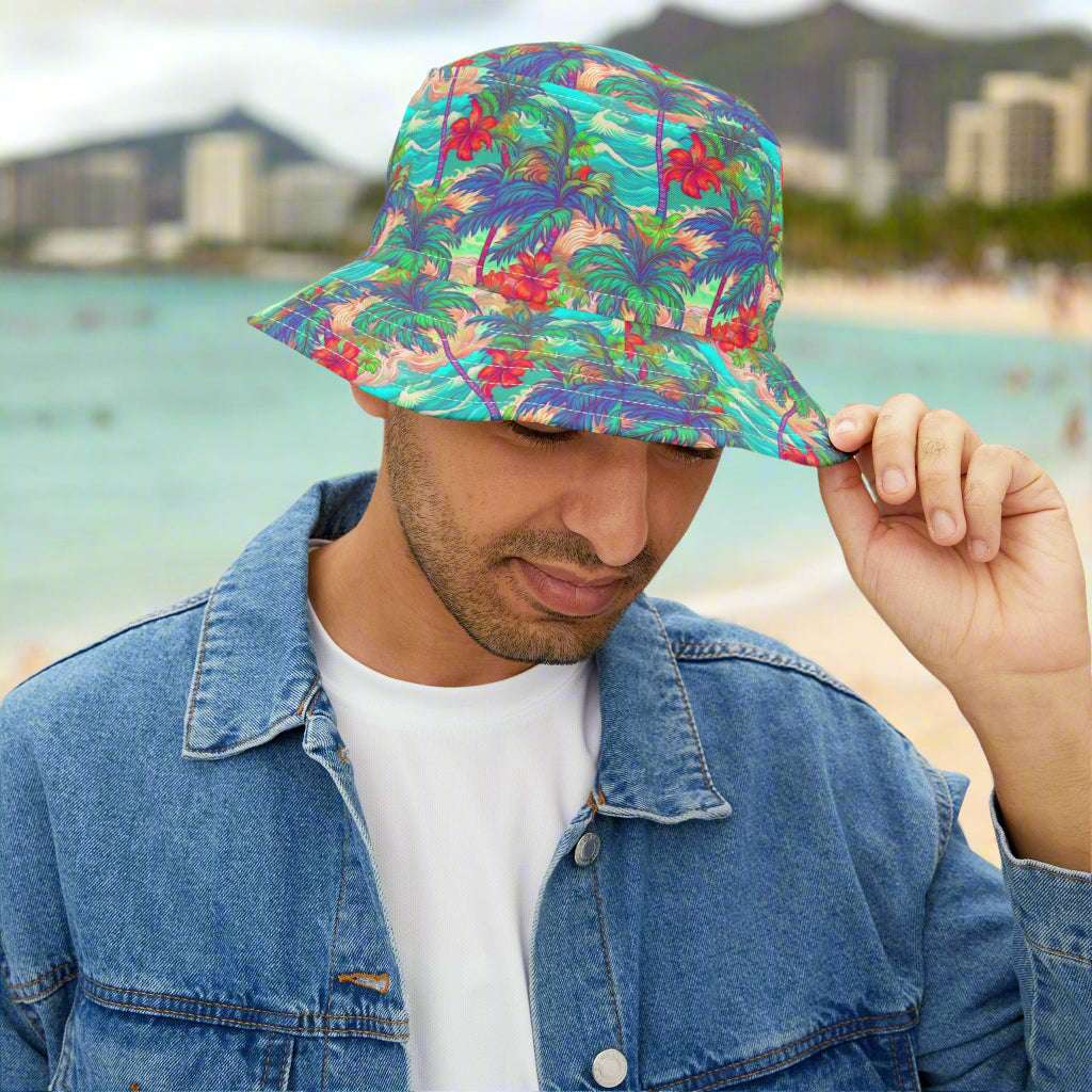 Guy tipping his Bongo Beachwear Bucket hat with a Hawaiian Style tropical pattern at Waikiki Beach