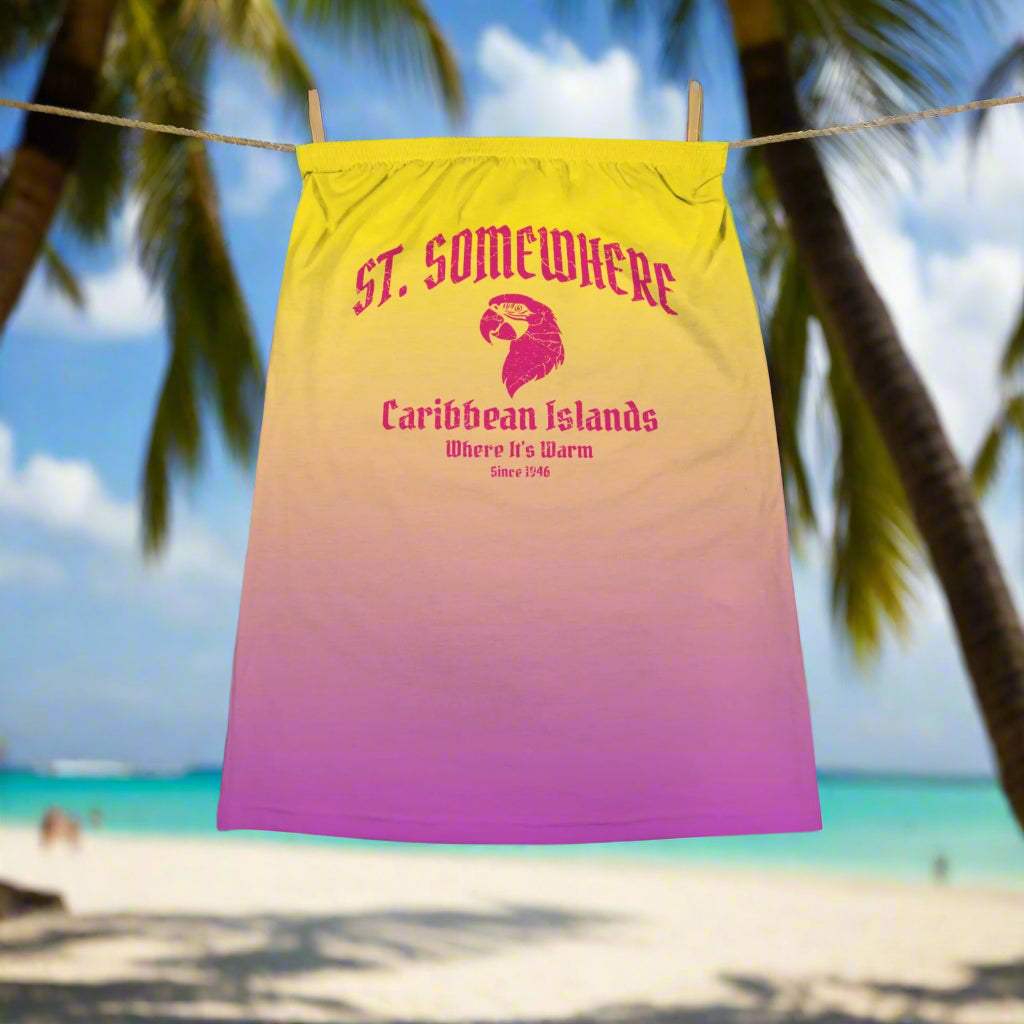 Sun Yellow to pink Ombré tube top with St. Somewhere Resort Logo hanging on line in a tropical island beach