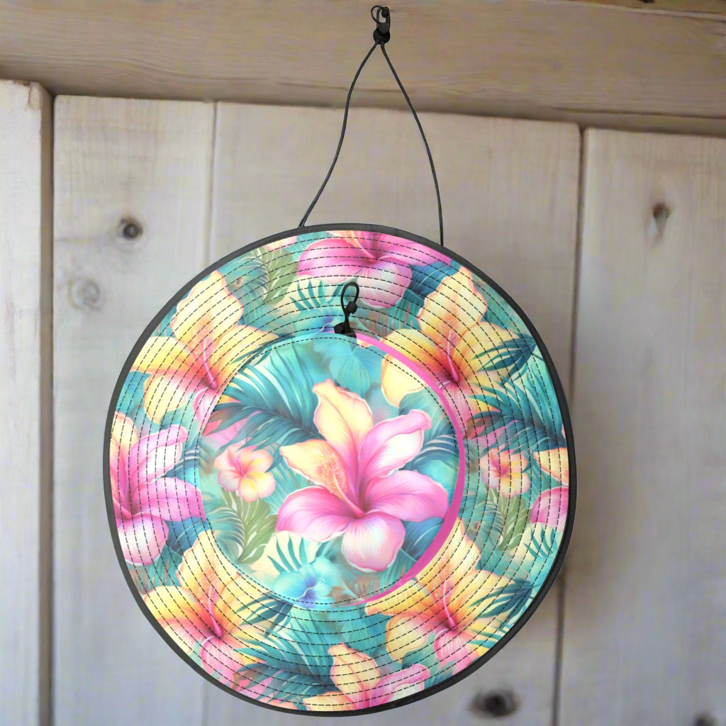 Colorful sun hat with floral pattern hanging on a hook in a seaside surf shack