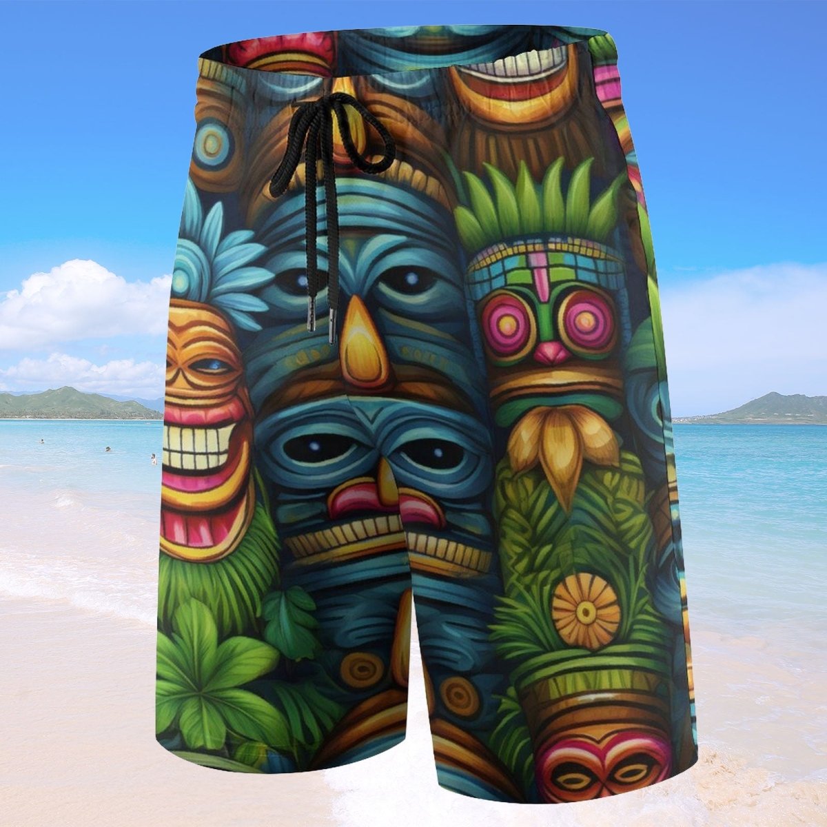Colorful tiki mask-themed shorts on a beach with ocean and sky background