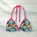 Colorful bikini top with tropical design on a white background