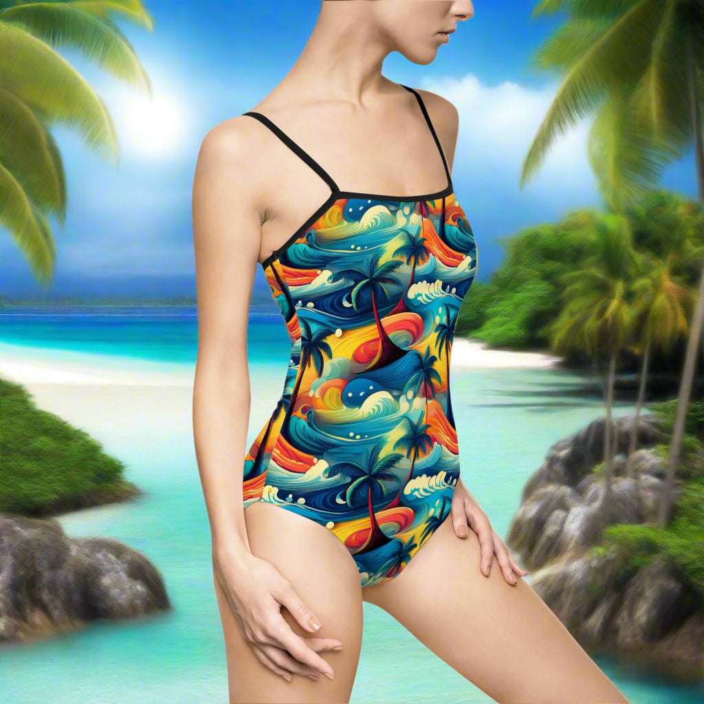 Model in one piece Hawaiian Style bathing suit sanding in sand watching the waves