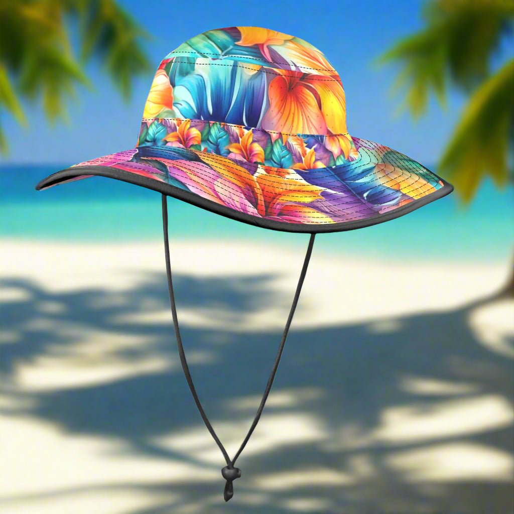 Colorful Hawaiian style floral bucket hat with a strap on a beach background