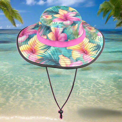 Colorful floral bucket hat with a pink band on a beachy background