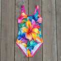 colorful floral swimsuit on a rustic nautical wood background