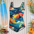 Girls one piece swimsuit with Hawaiian style print in front of a nautical looking wall with surf icons 