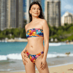 Swimsuit model wearing a Hawaiian Style bandeau bikini standing on the beach in Waikiki Hawaii