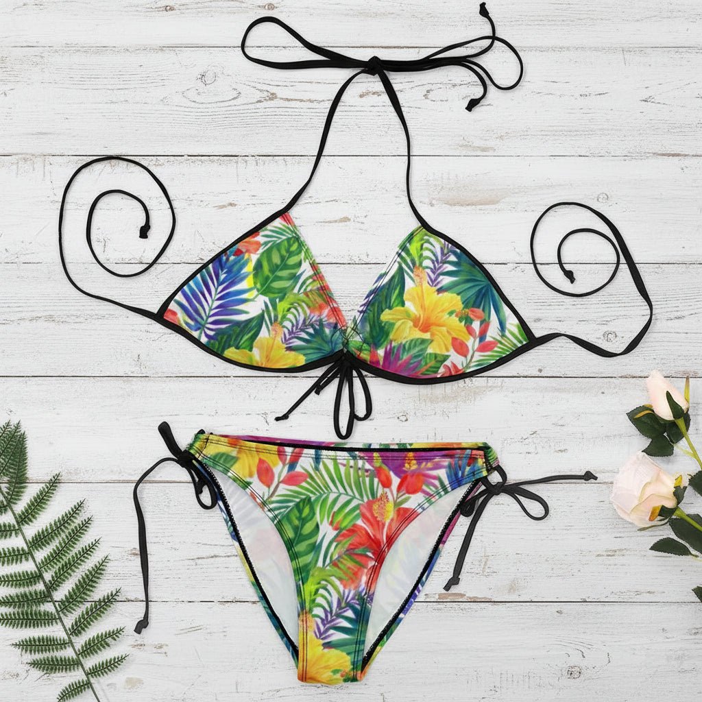 Colorful tropical print bikini set with floral and leaf patterns on a white background.