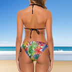 Woman wearing a colorful tropical print bikini with a beach background