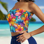 Colorful floral strapless top worn by a beachwear model standing in the sand of Waikiki Beach