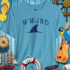 WWJBD Shark Fin Unisex Tee in blue, perfect for beach vibes and ParrotHeads, surrounded by nautical decor.