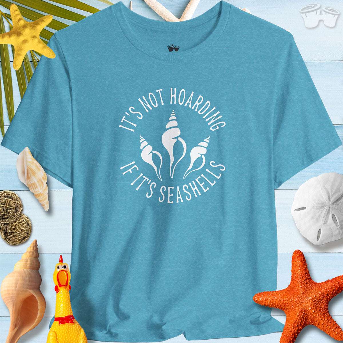 Beach Lover's Unisex Tee with 'It's Not Hoarding If It's Seashells' quote, perfect for shell collectors and beach lovers.