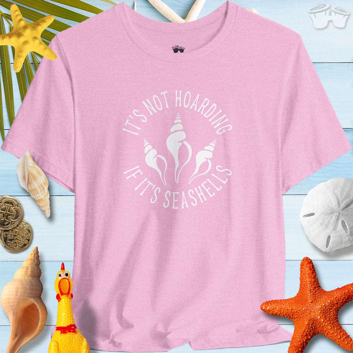 Beach Lover's Unisex Tee in pink with seashell design and quote 'It's Not Hoarding If It's Seashells' shirt.