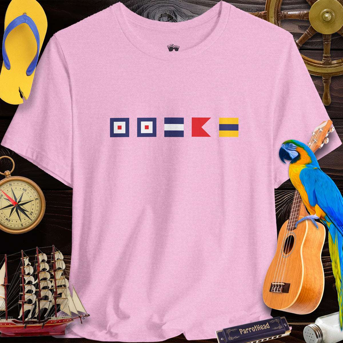 Nautical Signal Flags Tee in pink featuring WWJBD for ParrotHead fans, surrounded by beach-themed decor.