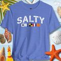 SALTY T-Shirt With A Coastal Vibe on a coastal background with seashells and starfish, perfect for ocean lovers.