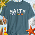 Salty nautical signal flags t-shirt on a beach-inspired background with shells and starfish.