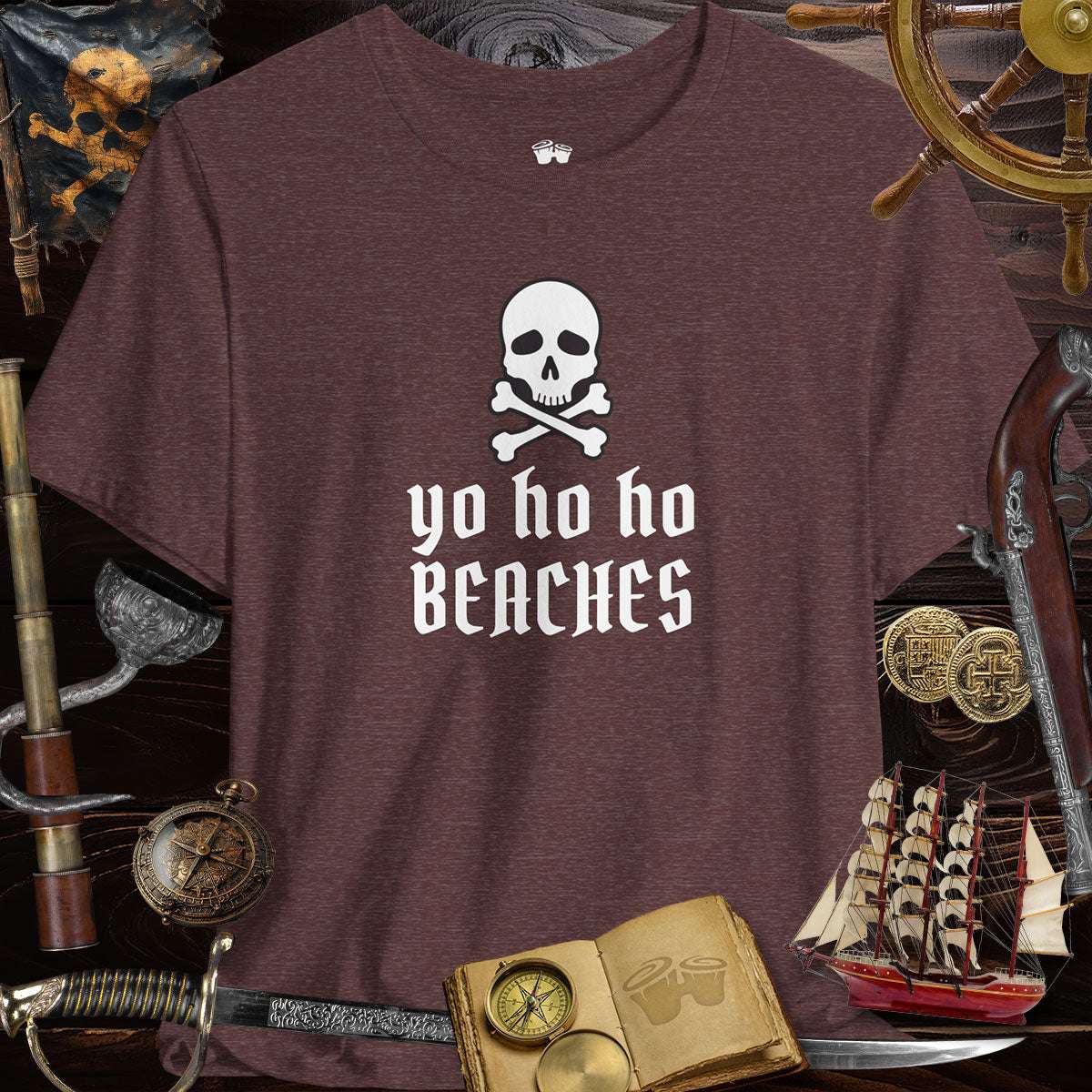 Yo Ho Ho Beaches Jolly Roger Pirate unisex tee on a dark background with pirate-themed accessories.