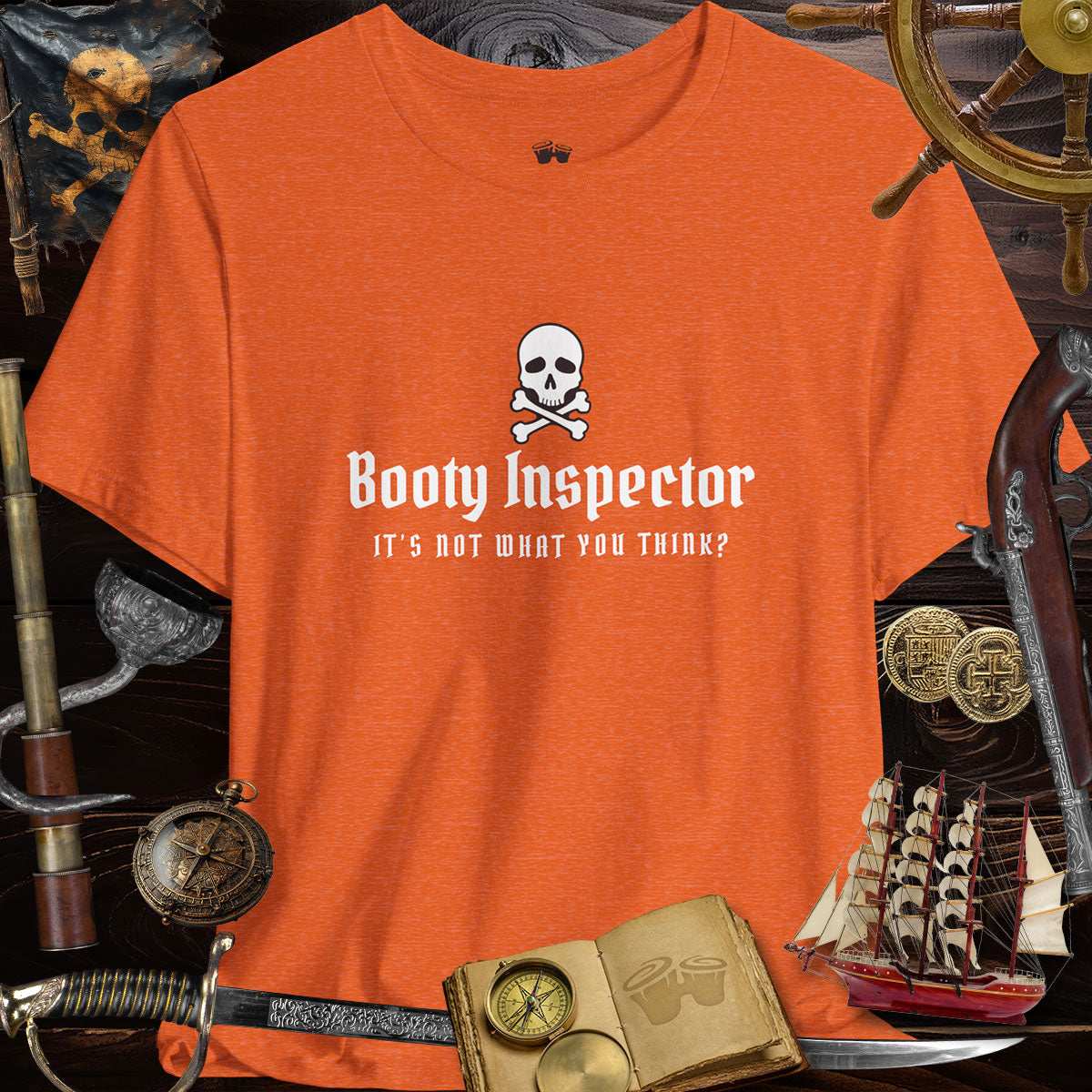 Booty Inspector Funny Pirate's Tee, orange shirt with skull and playful text, perfect for casual outings and humor lovers.